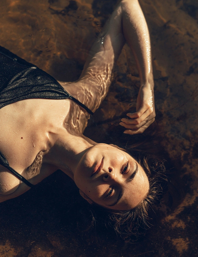 Woman in lingerie lying on ground with dramatic natural lighting and autumn leaves - Microdermabrasion in Newport Beach, CA